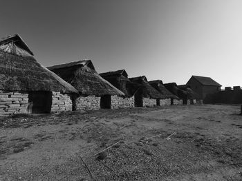 Abandoned house on field against clear sky