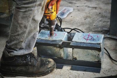 Low section of manual worker working on construction site