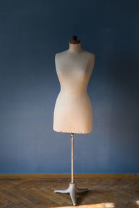 View of mannequin by wall