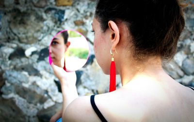 Reflection of woman on hand mirror