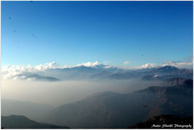 Scenic view of mountains against clear blue sky