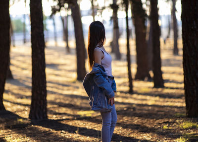 Rear view of woman standing on field