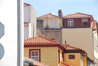 Residential buildings against sky on sunny day