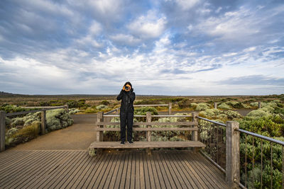 Woman taking a photograph at the australian bush