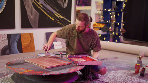 Full length of man sitting on table