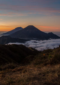 Scenic view of snowcapped mountains against sky during sunset