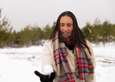 Smiling woman holding snow
