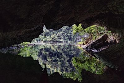 Scenic view of lake by rock formation