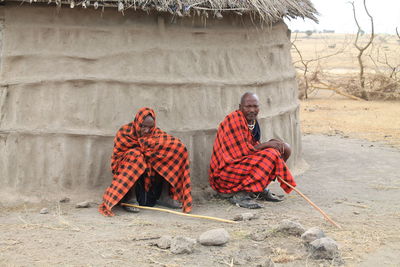 Rear view of men sitting outdoors