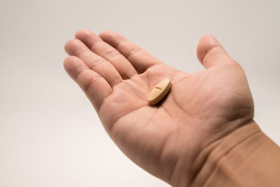 Close-up of hand against white background