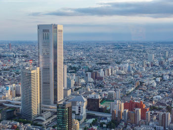 Aerial view of city buildings against sky