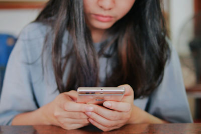 Midsection of woman using mobile phone