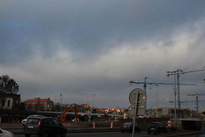 Cars on bridge in city against sky