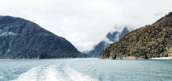 Panoramic view of sea and mountains against sky