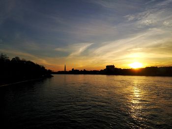 Scenic view of river against sky during sunset