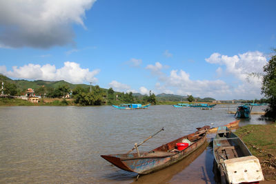 Boats moored in sea against sky