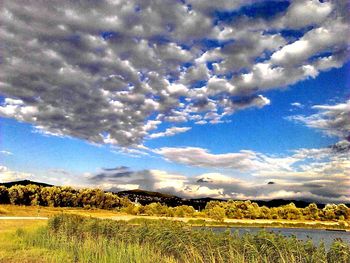 Scenic view of landscape against cloudy sky