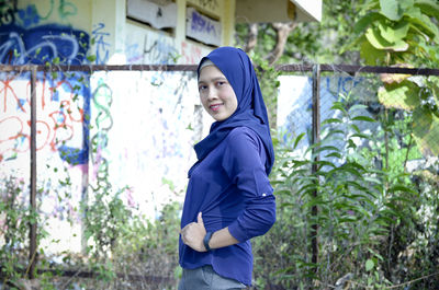 Portrait of young woman standing outdoors