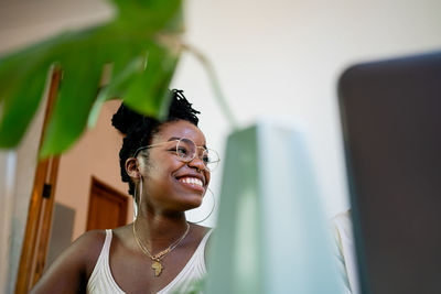 Portrait of a smiling young woman looking away
