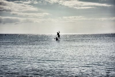 Full length of man standing on sea against sky