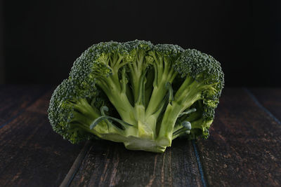 Close-up of green leaf on table against black background