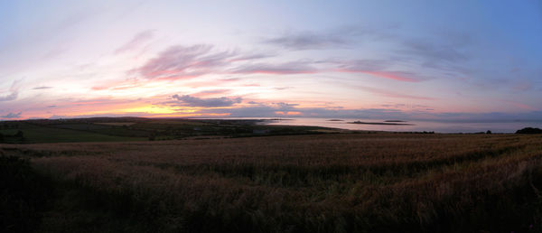 Scenic view of landscape against cloudy sky