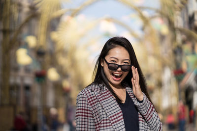Portrait of smiling young woman standing outdoors