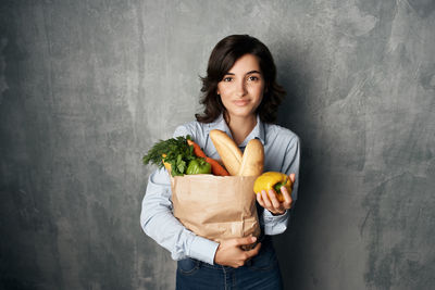 Portrait of smiling young woman against white background