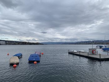 Boats in sea against sky