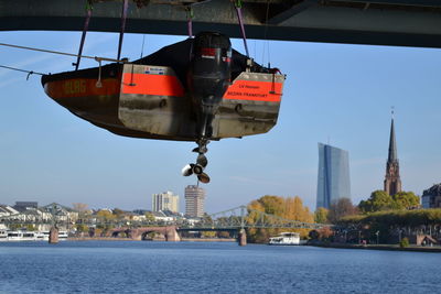 View of river and buildings against clear sky