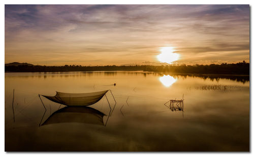 Scenic view of lake against sky during sunset