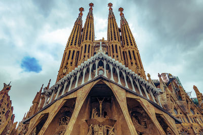 Low angle view of temple building against cloudy sky