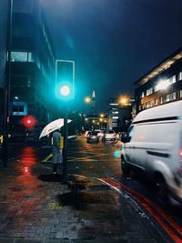 Cars on city street during rainy season at night