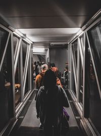 Rear view of people on escalator