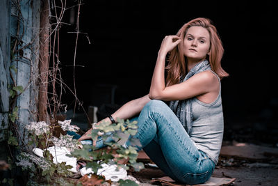 Portrait of young woman sitting outdoors