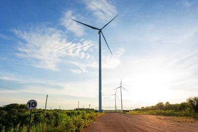 Windmill on field against sky