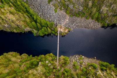 Aerial view of a suspension bridge crossing a canyon lake. hossa national park, finland