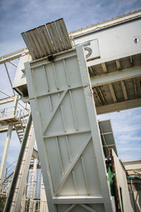 Low angle view of a boarding gateway for ferry boat against sky