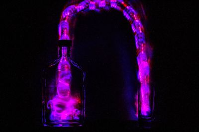 Close-up of purple water against black background