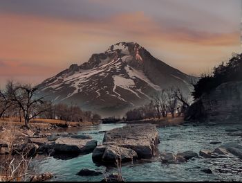 Scenic view of snowcapped mountains against sky during sunset