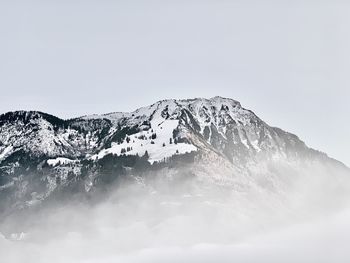 Snowcapped mountains against clear sky