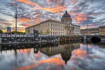 The reconstructed berlin city palace with the television tower before sunrise