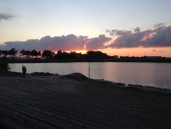 Scenic view of lake against sky during sunset