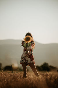 Full length of woman on field against clear sky