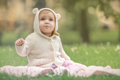 Full length of cute baby girl on field