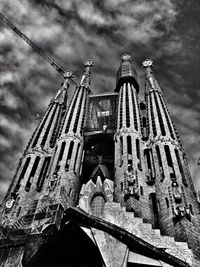 Low angle view of built structure against cloudy sky