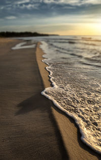 Close-up of sand on beach against sky