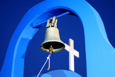 Low angle view of bell tower against blue sky