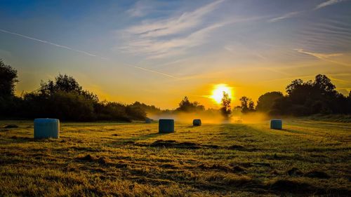 Scenic view of field against sky during sunset