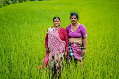 Portrait of smiling women standing on farm